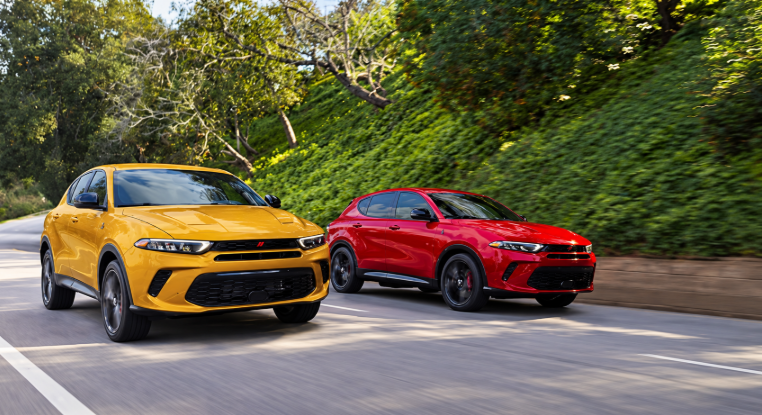 Dodge Hornet SUVs driving on tree-lined road