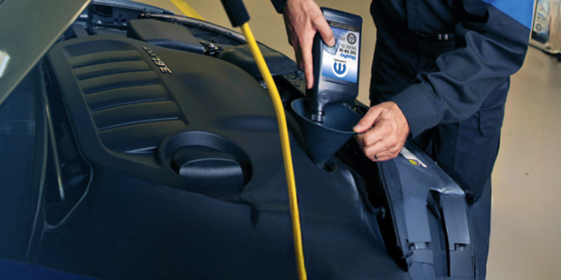 Mopar certified technician during oil change process