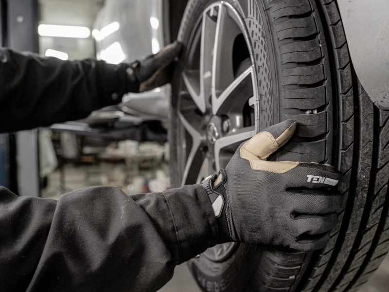 technician changing vehicle tire during tire service